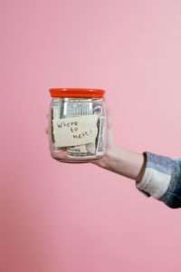 Jar full of Money held by a Person