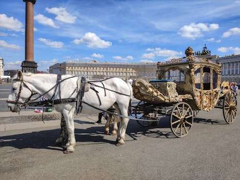 Elegant horse-drawn carriage at Palace Square in St. Petersburg on a clear day.