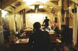 Vintage scene of officers working in a historic war room with maps and desks.